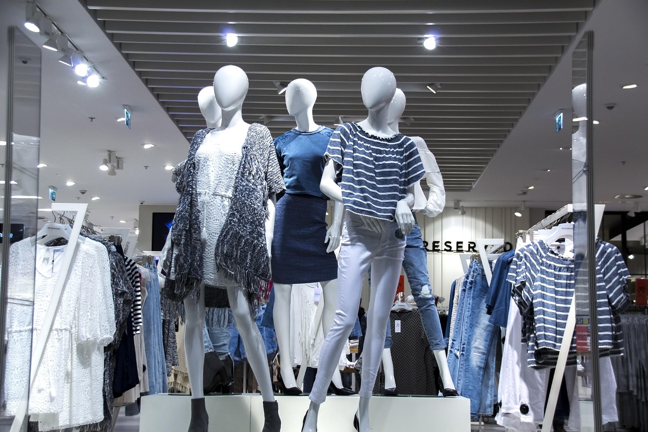 A display of mannequins wearing various clothing items inside a retail store.
