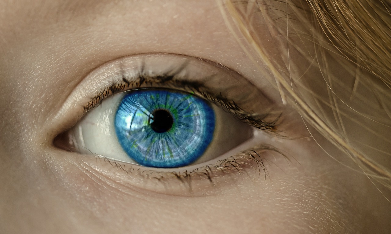 A close-up of a human eye with a bright blue iris.