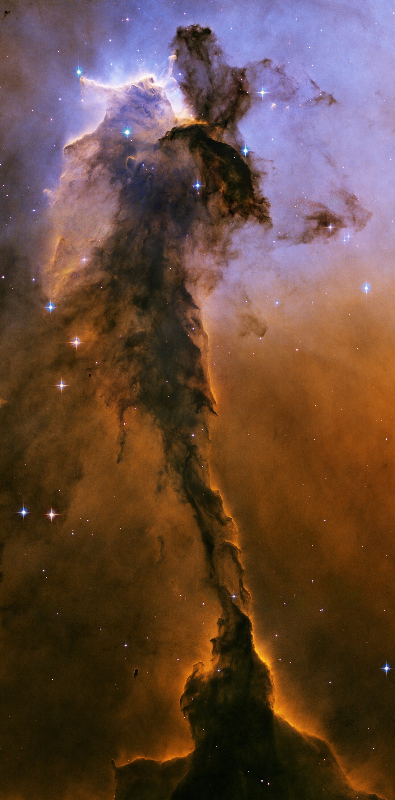 A detailed, high-resolution view of the Pillars of Creation within the Eagle Nebula, showing glowing gas and dust clouds.