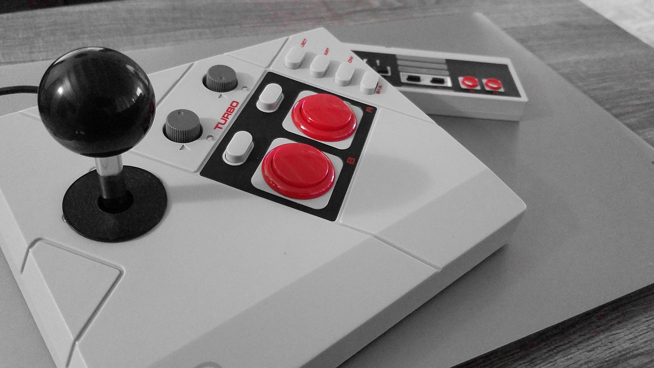 A vintage video game controller with a joystick and buttons.