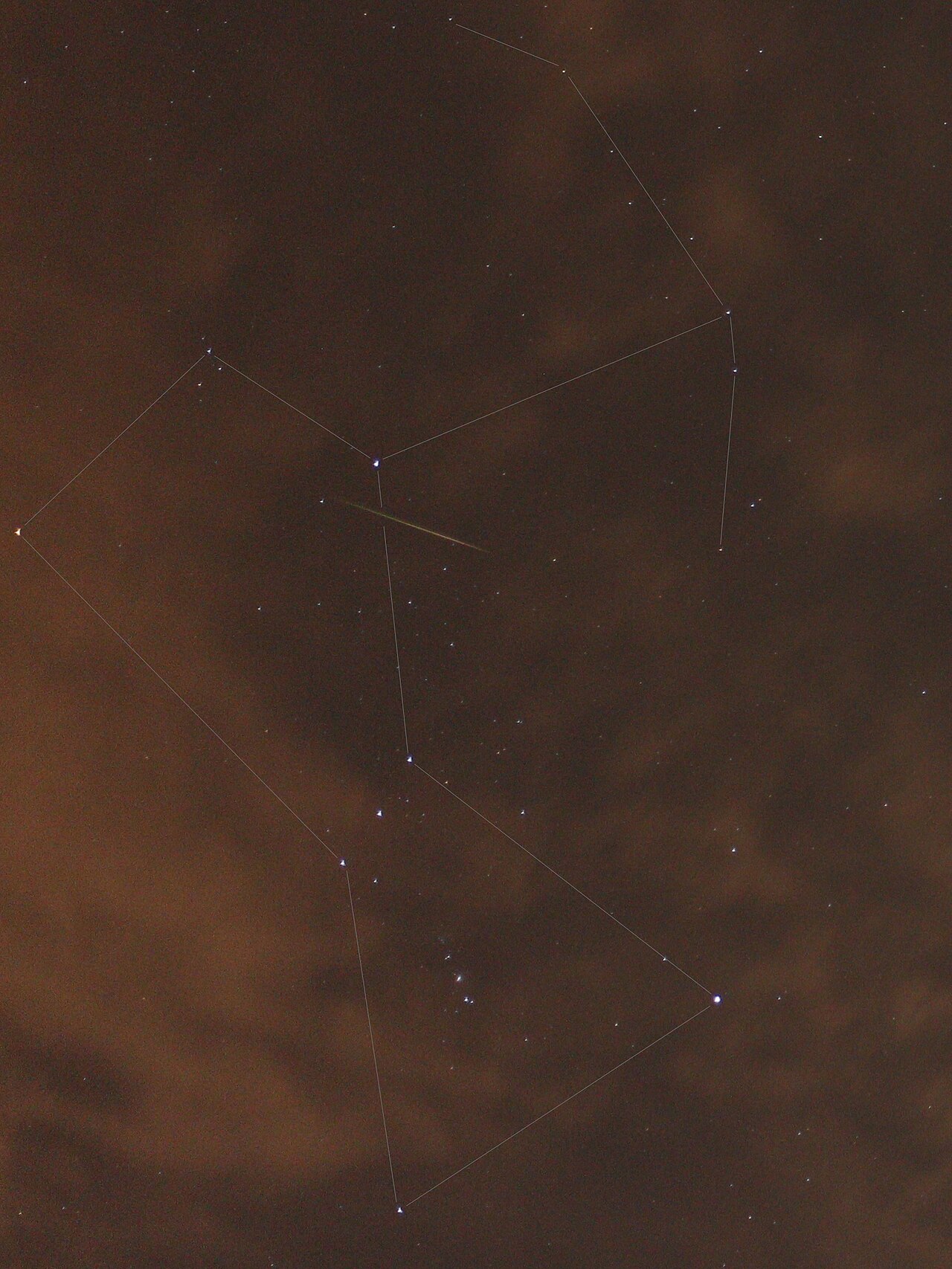 A meteor streaks across the night sky against the backdrop of the Orion constellation, with lines overlaid connecting the stars.