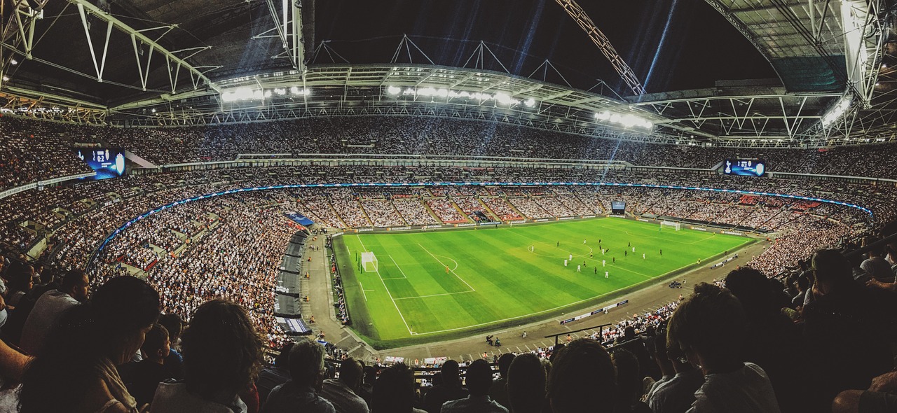 A packed football stadium at night