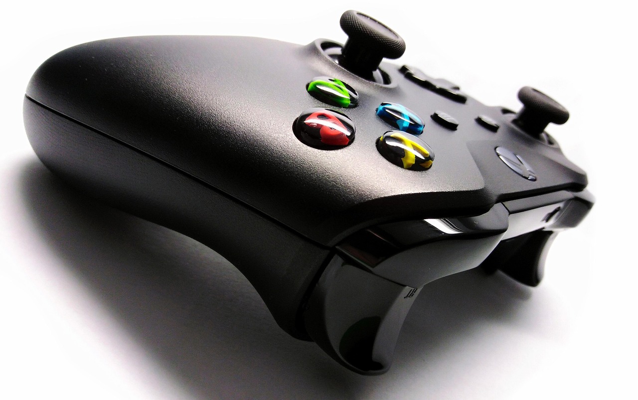 A black video game controller on a white background.