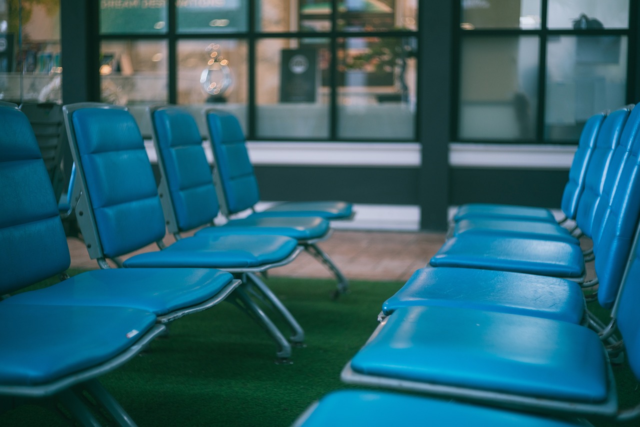 Rows of empty blue airport terminal chairs