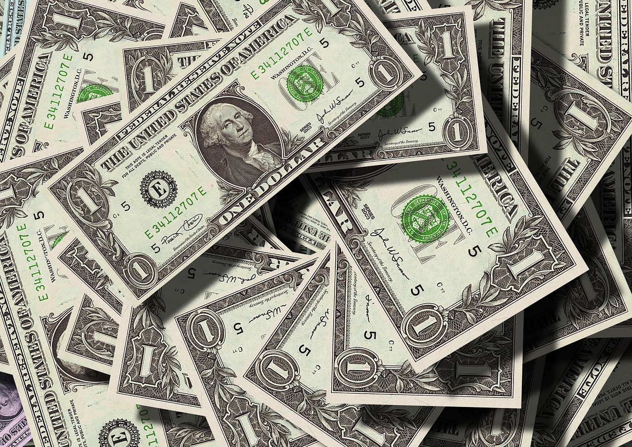 A pile of one-dollar bills representing money and financial loss.