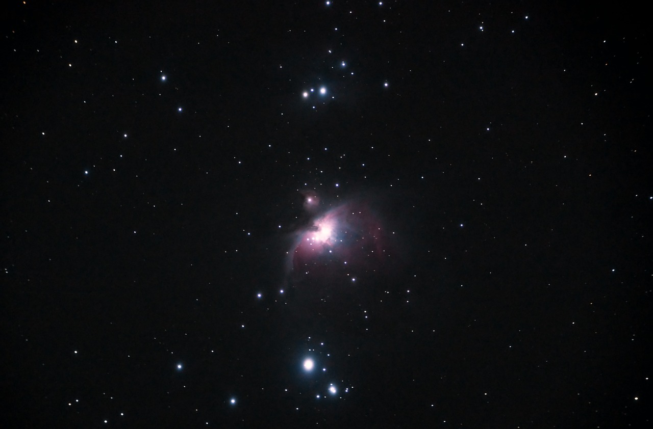 A clear view of the Great Nebula in Orion, showing a glowing cloud of gas and dust surrounded by bright stars in the night sky.