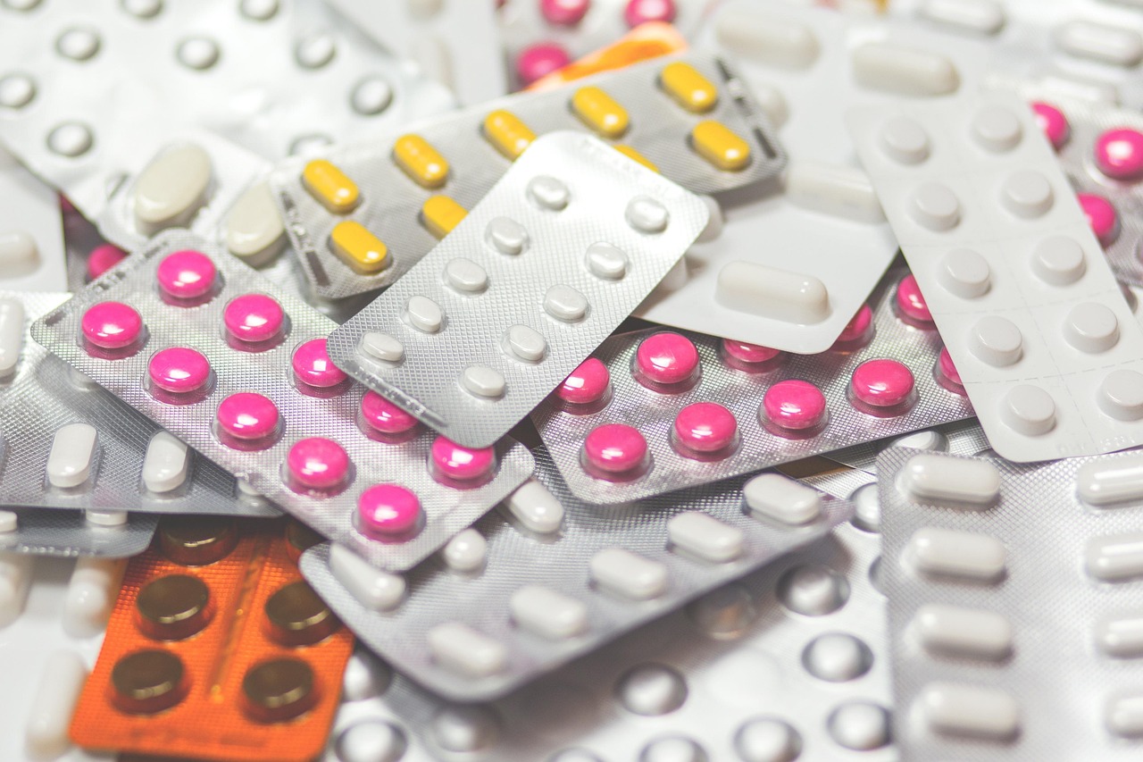 A collection of various blister packs containing different types of pills.